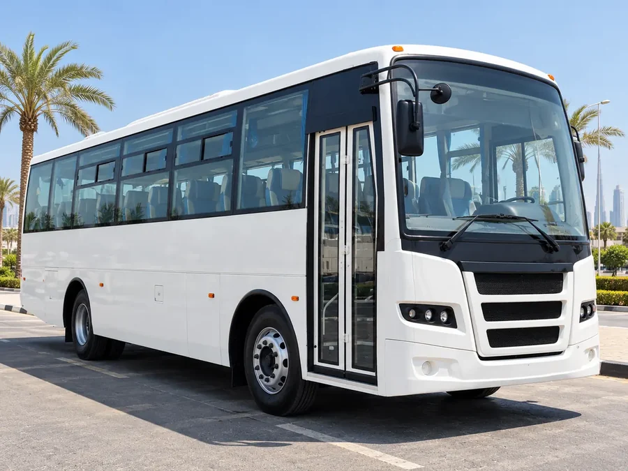 Ashok Leyland Falcon 71–84 seater labour bus rental Dubai — front three-quarter view